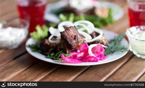 pieces of grilled meat on wooden table