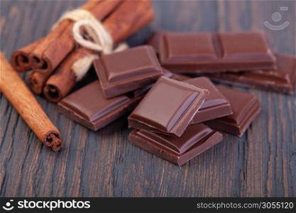Pieces of natural dark chocolate on wooden table. dark chocolate