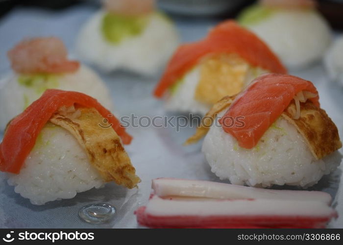 Pieces of nigirisushi: rice with a salmon or scrimp topping