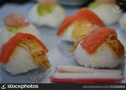 Pieces of nigirisushi: rice with a salmon or scrimp topping