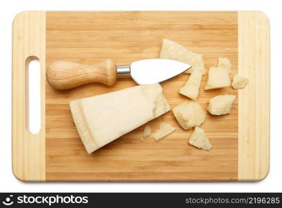 pieces of Parmesan cheese on wooden cutting board. white background. pieces of Parmesan cheese on wooden cutting board