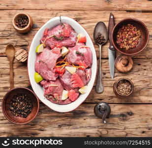 Pieces of raw beef steaks.Fresh meat with ingredients for cooking.Citrus marinade. Beef meat in citrus marinade