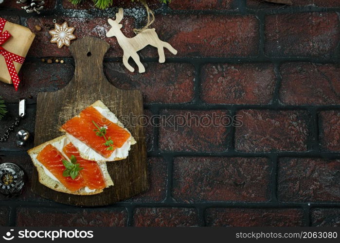 Pieces of red fish and butter on rye bread