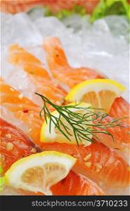 pieces of red fish and lemon on ice