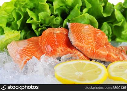 pieces of red fish and lettuce on ice