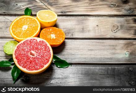 Pieces of ripe citrus. On wooden background. Pieces of ripe citrus.