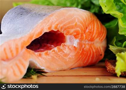 pieces of salmon on wooden plate