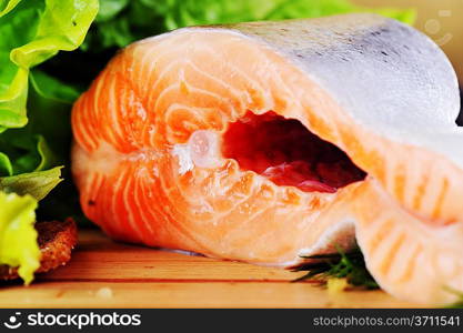 pieces of salmon on wooden plate