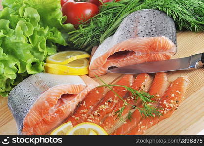 pieces of salmon with spice,lemon and lettuce