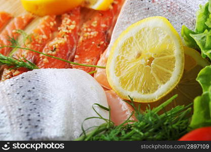 pieces of salmon with spice on wooden plate