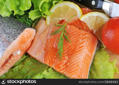 pieces of salmon with spice on wooden plate