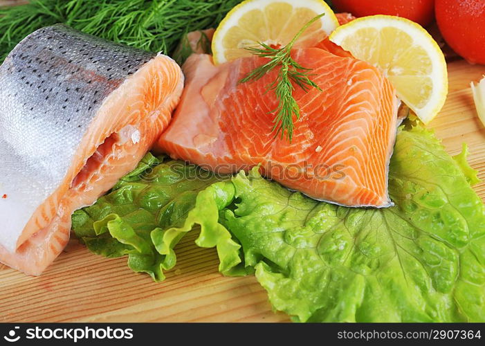 pieces of salmon with spice on wooden plate