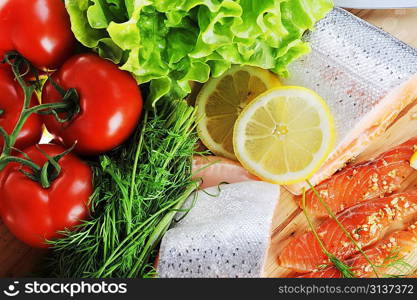 pieces of salmon with spice on wooden plate