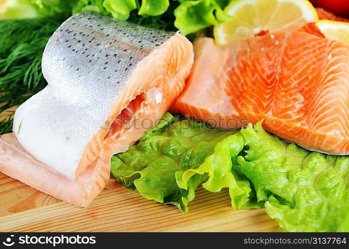 pieces of salmon with spice on wooden plate