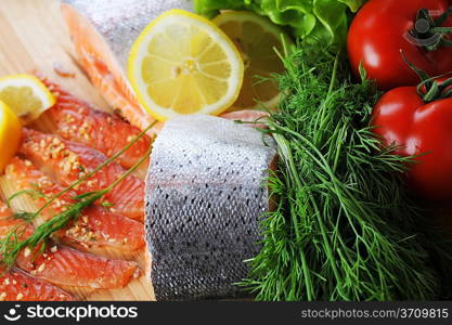 pieces of salmon with spice on wooden plate