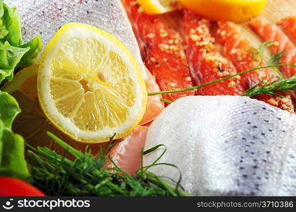 pieces of salmon with spice on wooden plate