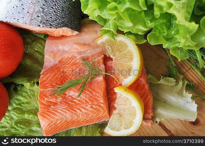 pieces of salmon with spice on wooden plate