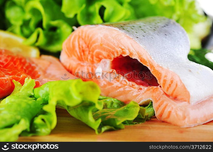 pieces of salmon with spice on wooden plate