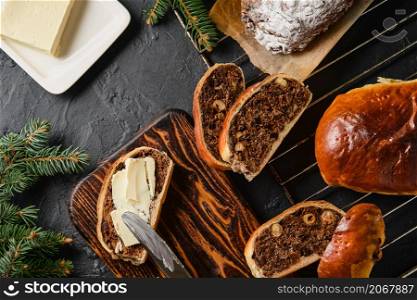 Pieces of Swiss Pear Bread - Bundner Birnbrot, layout on the table. Traditional Christmas and New Year?s meal. Birnbrot is smeared with butter and served with coffee. View from above