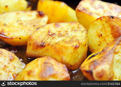 Pieces of tasty roast potato close up