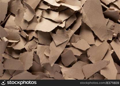 Pieces of torn paper as background texture. Recycling concept and heap of waste cardboard