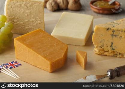 Pieces of traditional english cheese on a cheeseboard