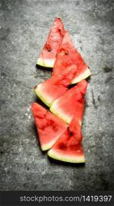pieces of watermelon. On the stone table.. pieces of watermelon.