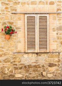 Pienza, Tuscany region, Italy. Old window with flowers