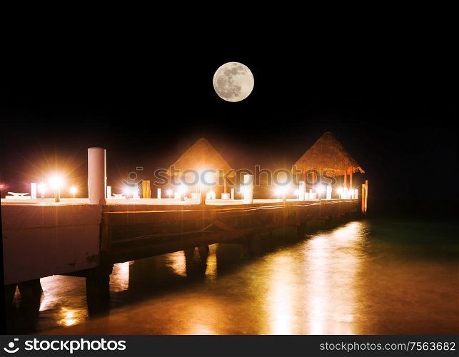 Pier at night in tropical resort