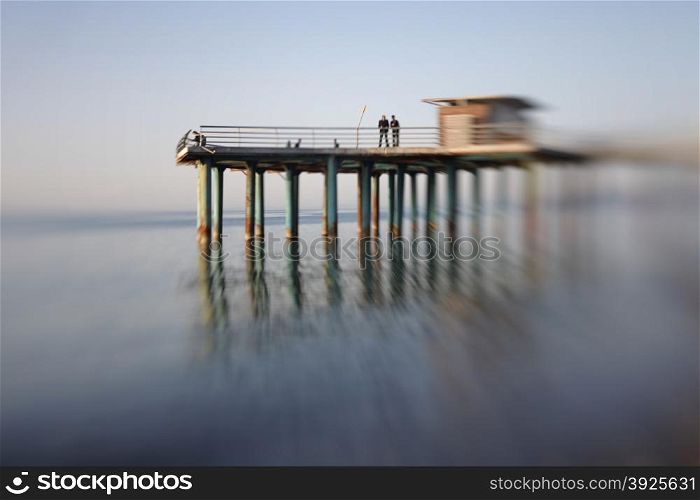 Pier in sea water. Soft focus. Made with lens-baby.