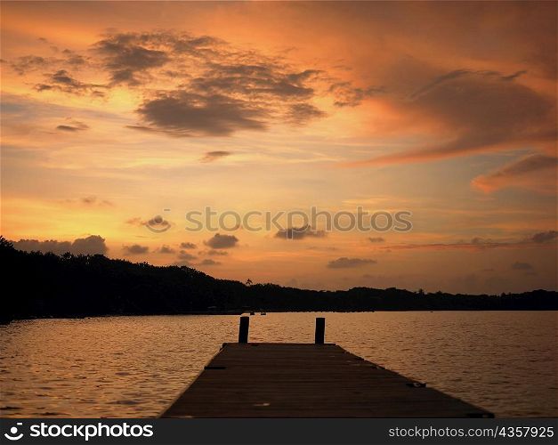Pier in the sea at sunset