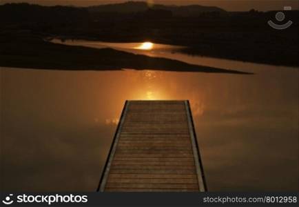 Pier over beautiful sunset on the river, horizontal image