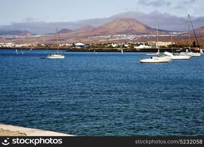 pier rusty chain water boat yacht coastline and summer in lanzarote spain