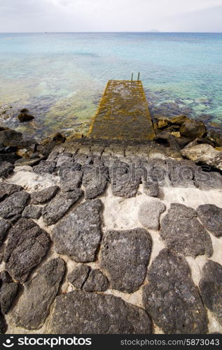 pier rusty chain water boat yacht coastline and summer in lanzarote spain&#xA;