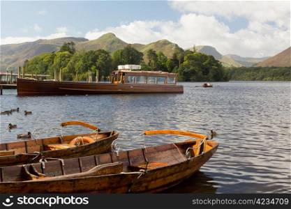 Piers and boats on edge of Derwentwater in English Lake District in early morning