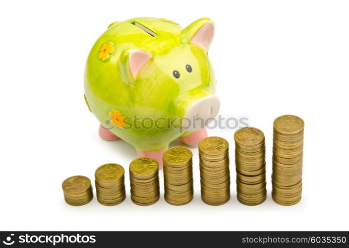 Piggy bank and coins isolated on white