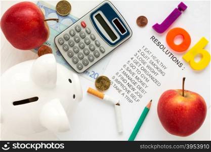 Piggy-bank,apples and office supply on list of resolutions