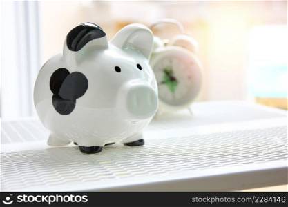 piggy bank black and white color with blur alarm clock