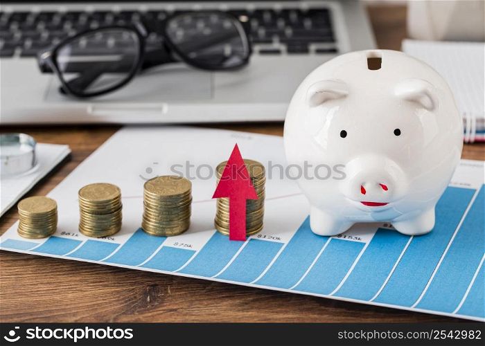 piggy bank growth chart with coins laptop