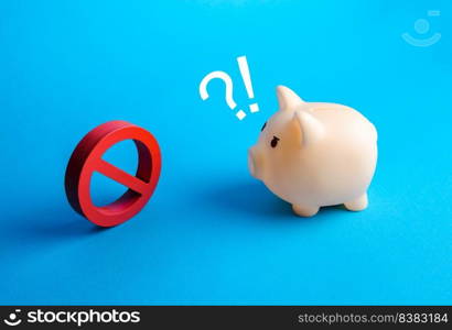 Piggy bank in surprised from the sanctions. Freezing, blocking of assets. Economic embargo. Savings confiscation. Loan disapproval. Bad credit history. Business restrictions.