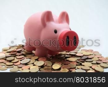 Piggy bank on a pile of euro coins