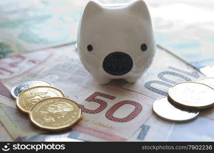 Piggy bank on Canadian money background