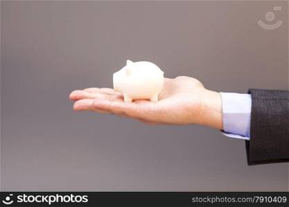 piggy bank on man hand isolated on gray