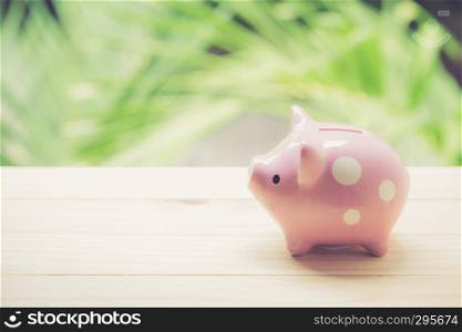 piggy bank on table with nature background, business concept.