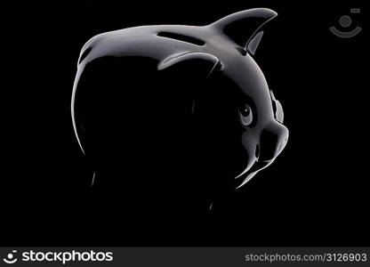 Piggy bank silhouette over black