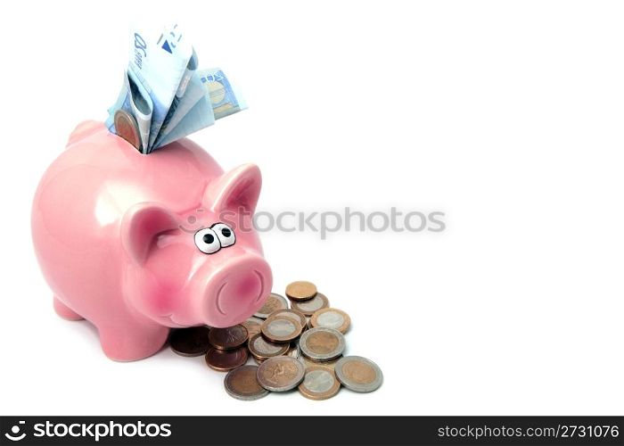 Piggy bank stuffed with money and surrounded by coins.