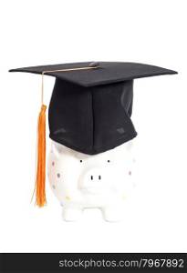 Piggy bank with black graduation hat isolated on white background.
