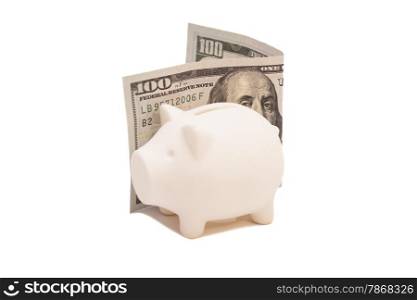 Piggy bank with hundred dollar bill isolated on white background