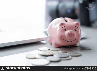 piggy bank with money coins on white table.saving money wealth and financial concept