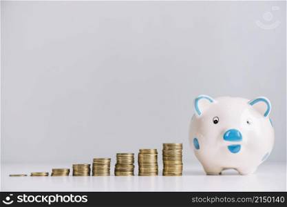piggybank increasing stacked coins reflective desk
